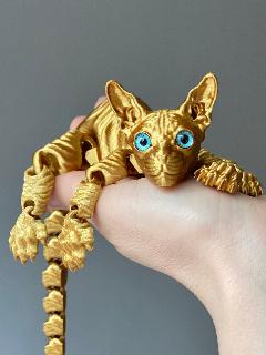Игрушка антистресс Кот сфинкс подвижный, пластик, золотой, 22,5см, стеклянные глаза, золотистый, 22.5x3.6 см